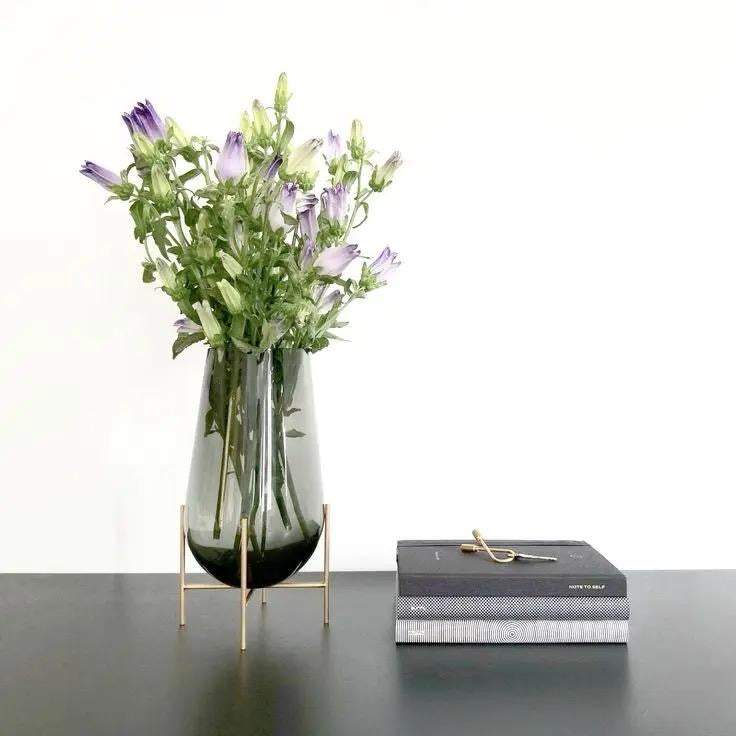 Modern creative dark glass vase with a gold stand