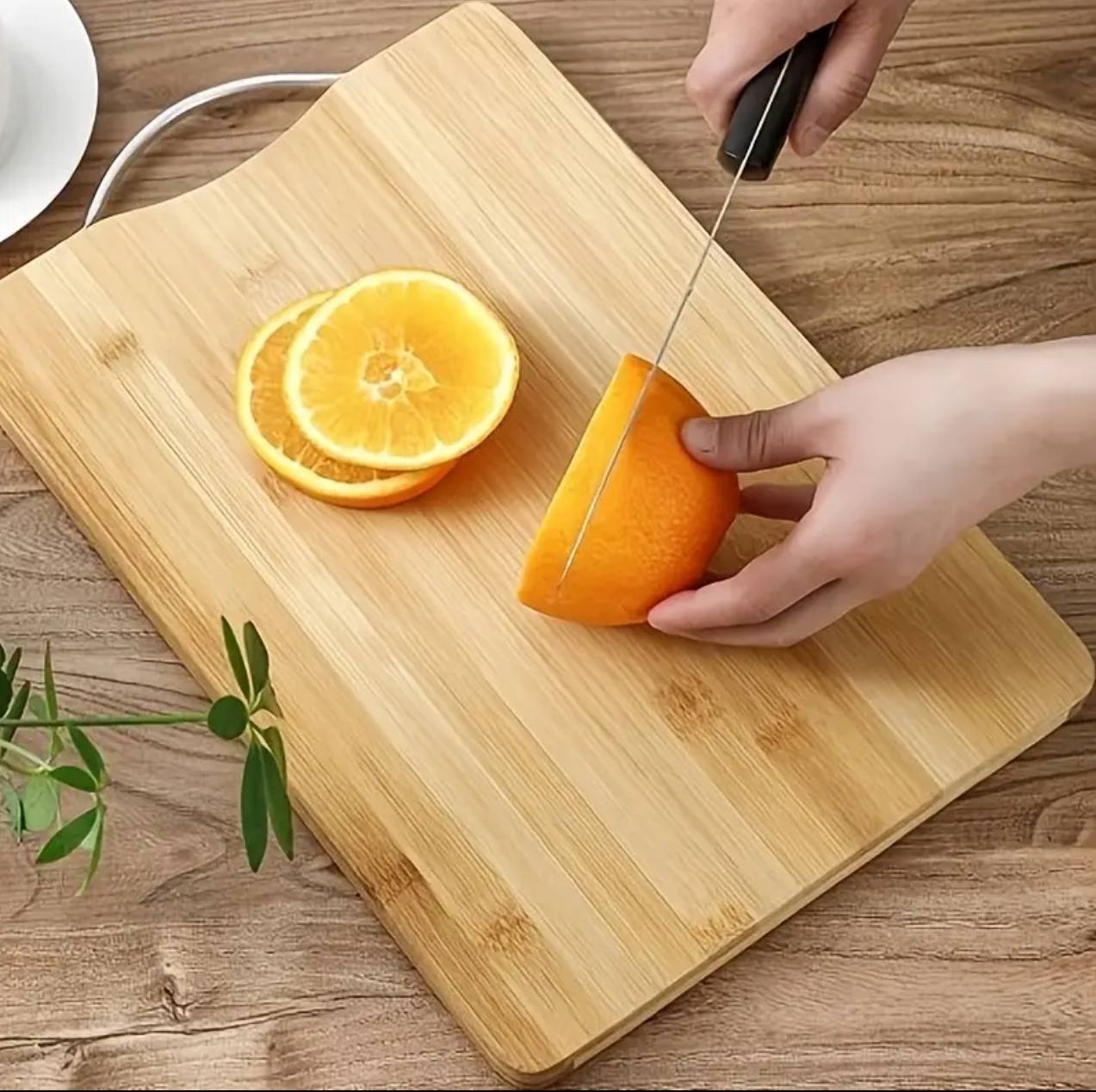 Heavy wooden chopping board with metallic handle.